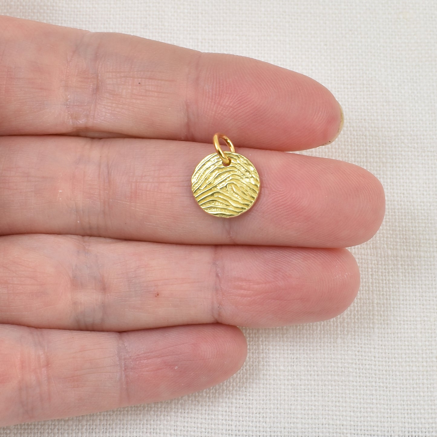 22 karat Gold Circle Fingerprint Pendant Shown on hand for size reference