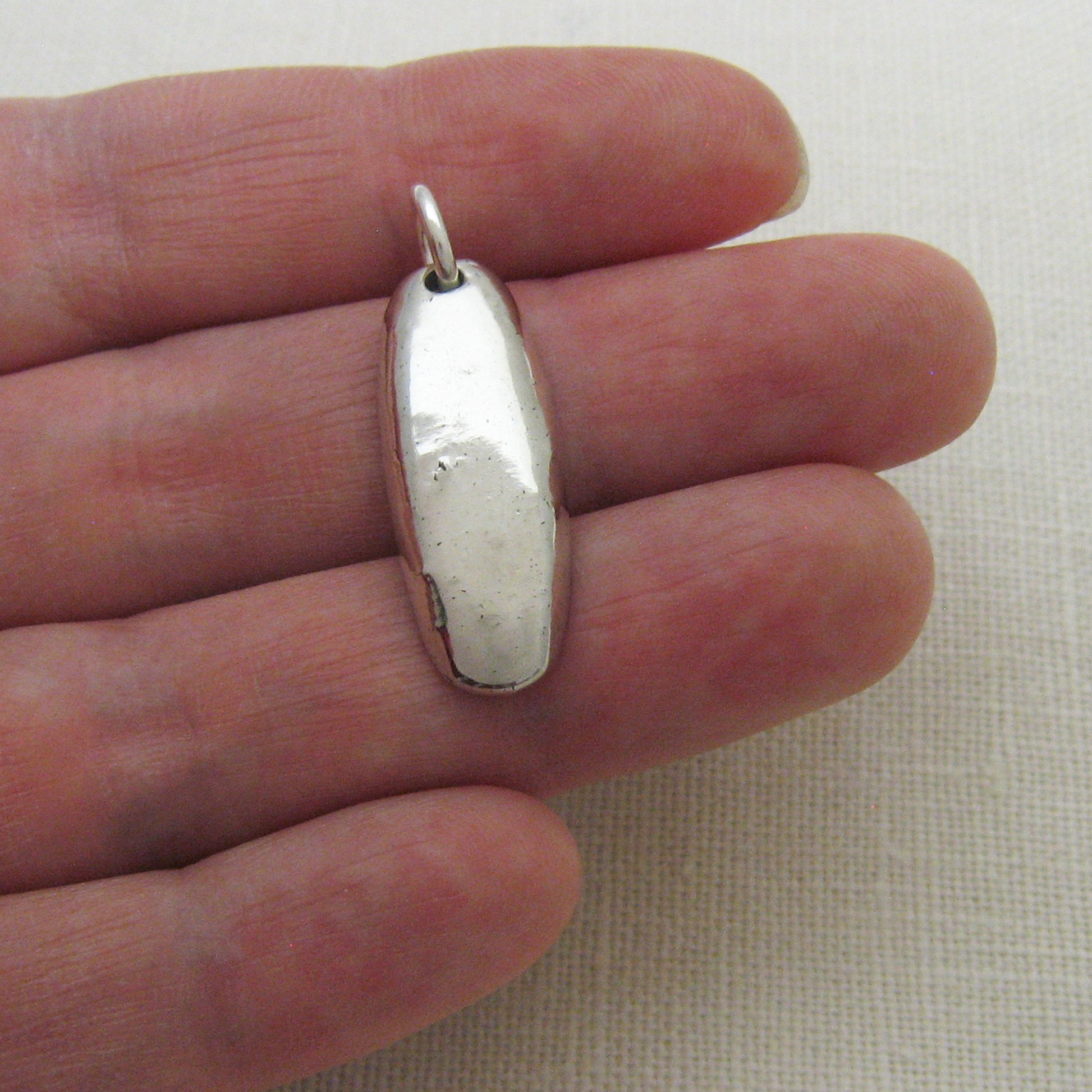 Silver Bar Cremation Ashes Pendant Shown on Hand for Size Reference