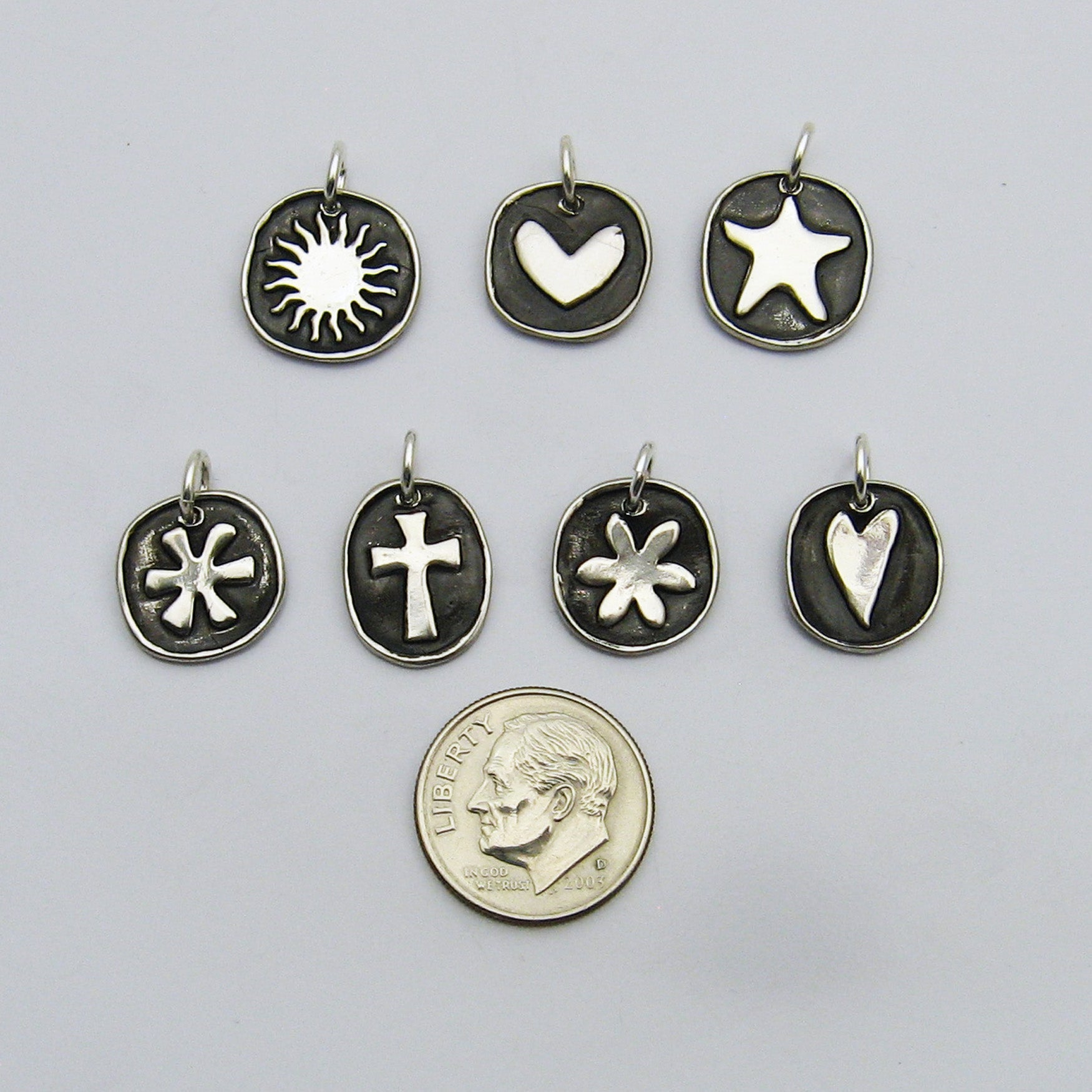 Sterling Silver Symbolic Charms Sun, Heart, Starfish, Asterisk, Cross, Flower, Long Heart With Dime for Size Reference
