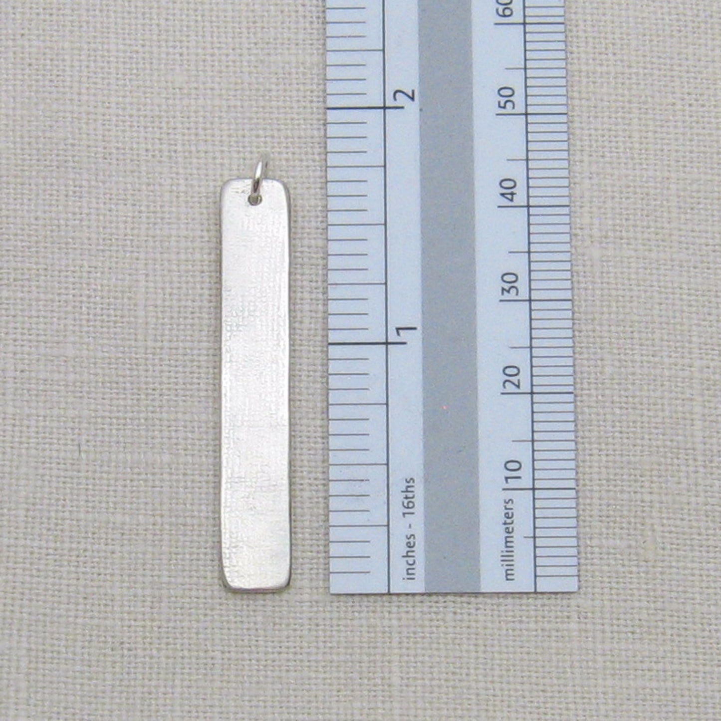 Braille Bar Pendant back shown with ruler for size reference