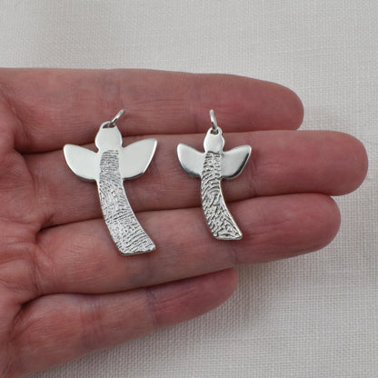 Angel Fingerprint Pendants shown on hand for size reference