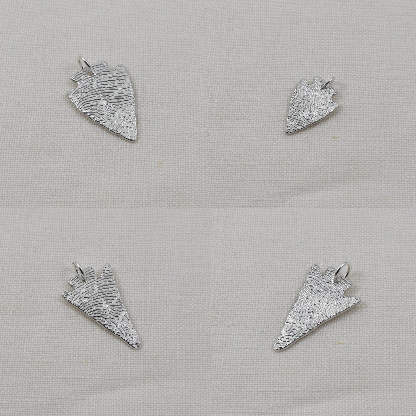 Four Arrowhead Fingerprint Pendants