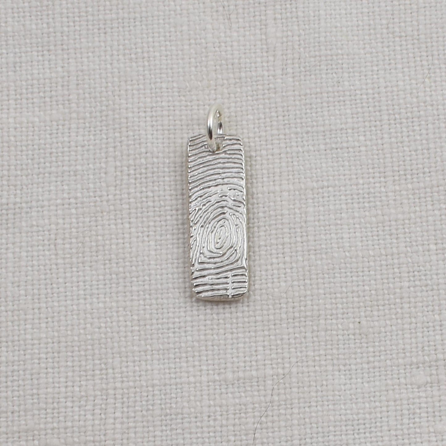 Sterling Silver Fingerprint Bar Pendant measures one quarter inch by three quarter inch