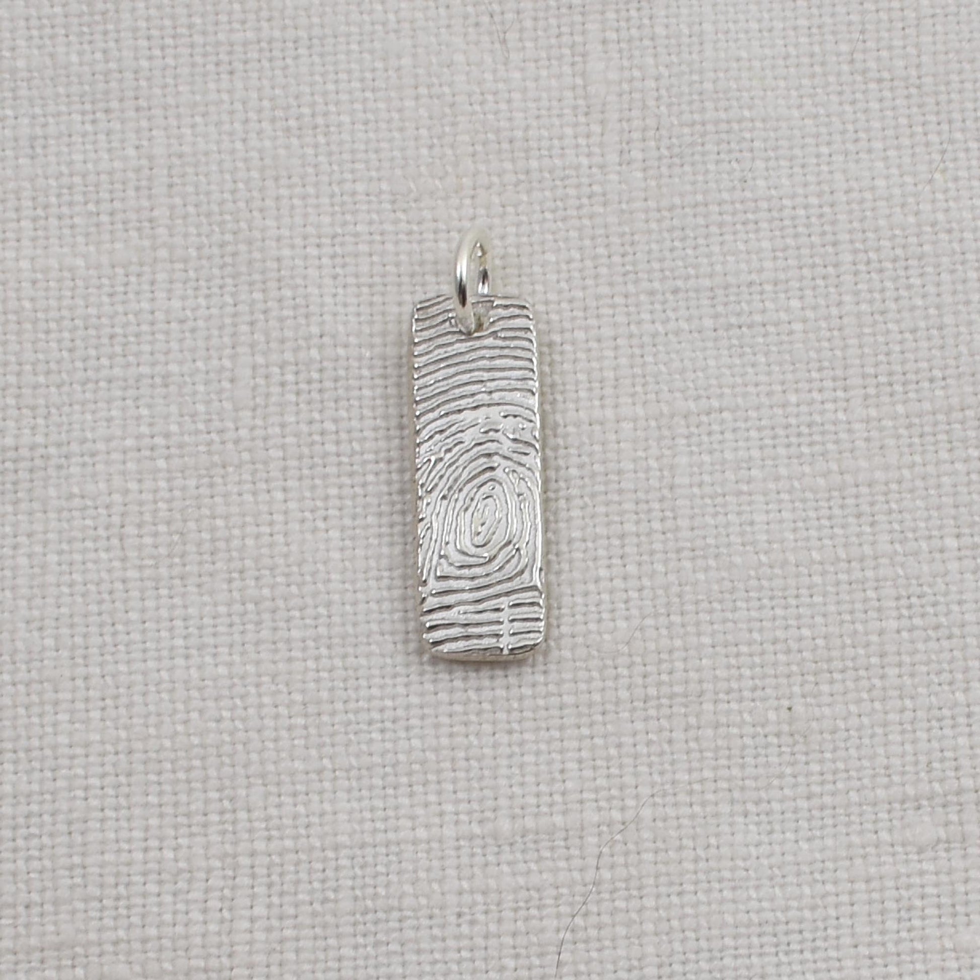 Sterling Silver Fingerprint Bar Pendant measures one quarter inch by three quarter inch