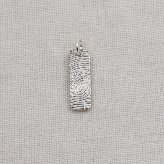 Sterling Silver Fingerprint Bar Pendant measures one quarter inch by three quarter inch