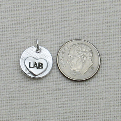 Back of Circle Pendant showing Small engraved heart next to dime for size reference