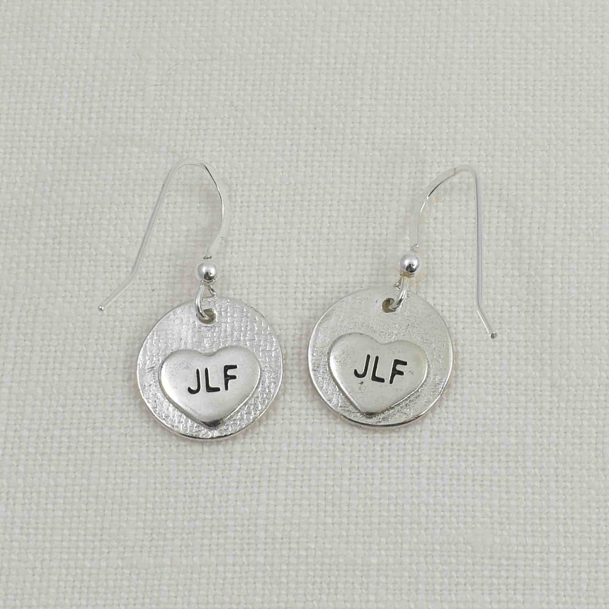 Back of Fine Silver Circle Fingerprint Earrings showing small engraved hearts