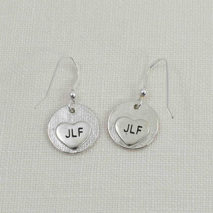 Back of Fine Silver Circle Fingerprint Earrings showing small engraved hearts