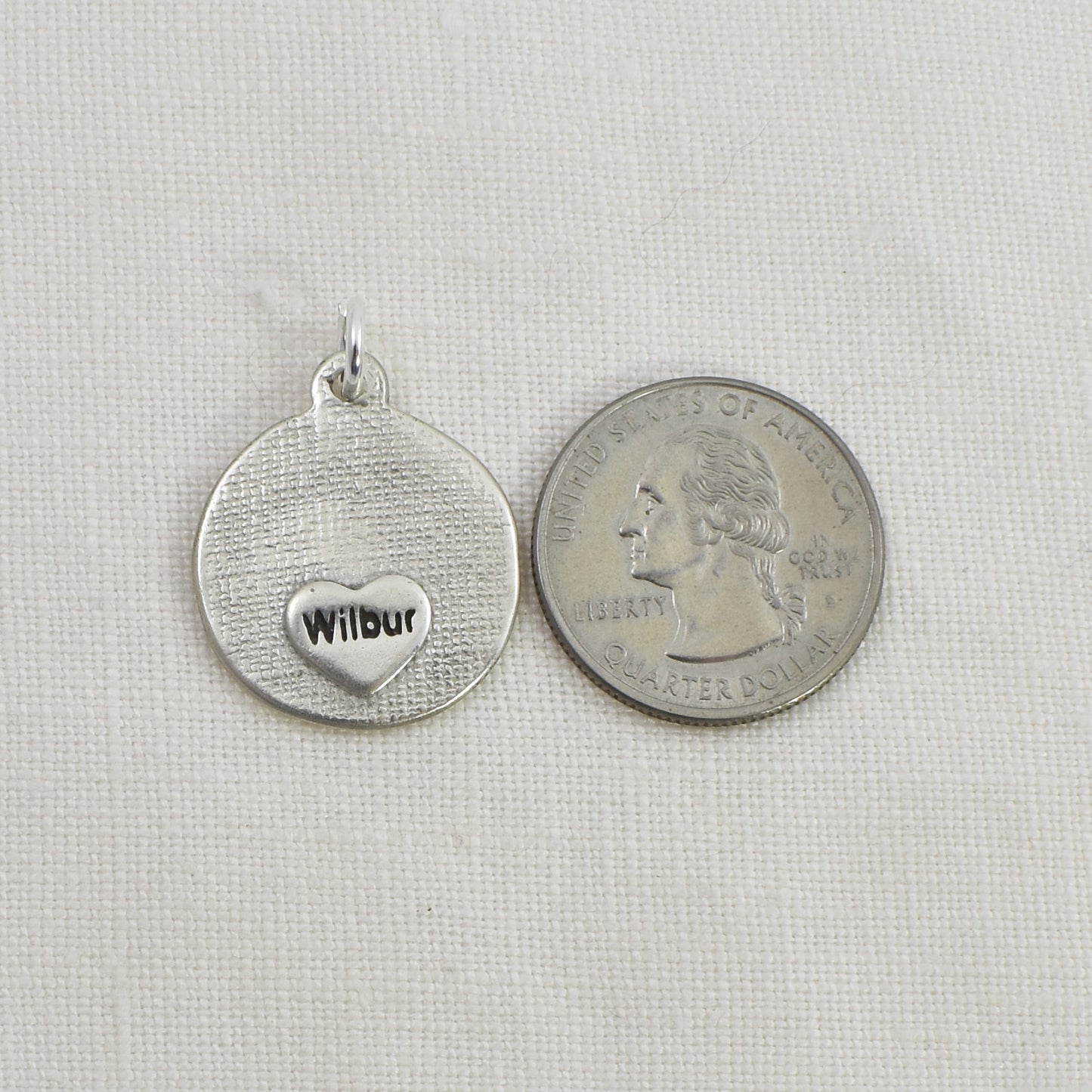 Dog Nose Embossed Circle Pendant, Necklace or Keychain back and shown next to quarter for size reference