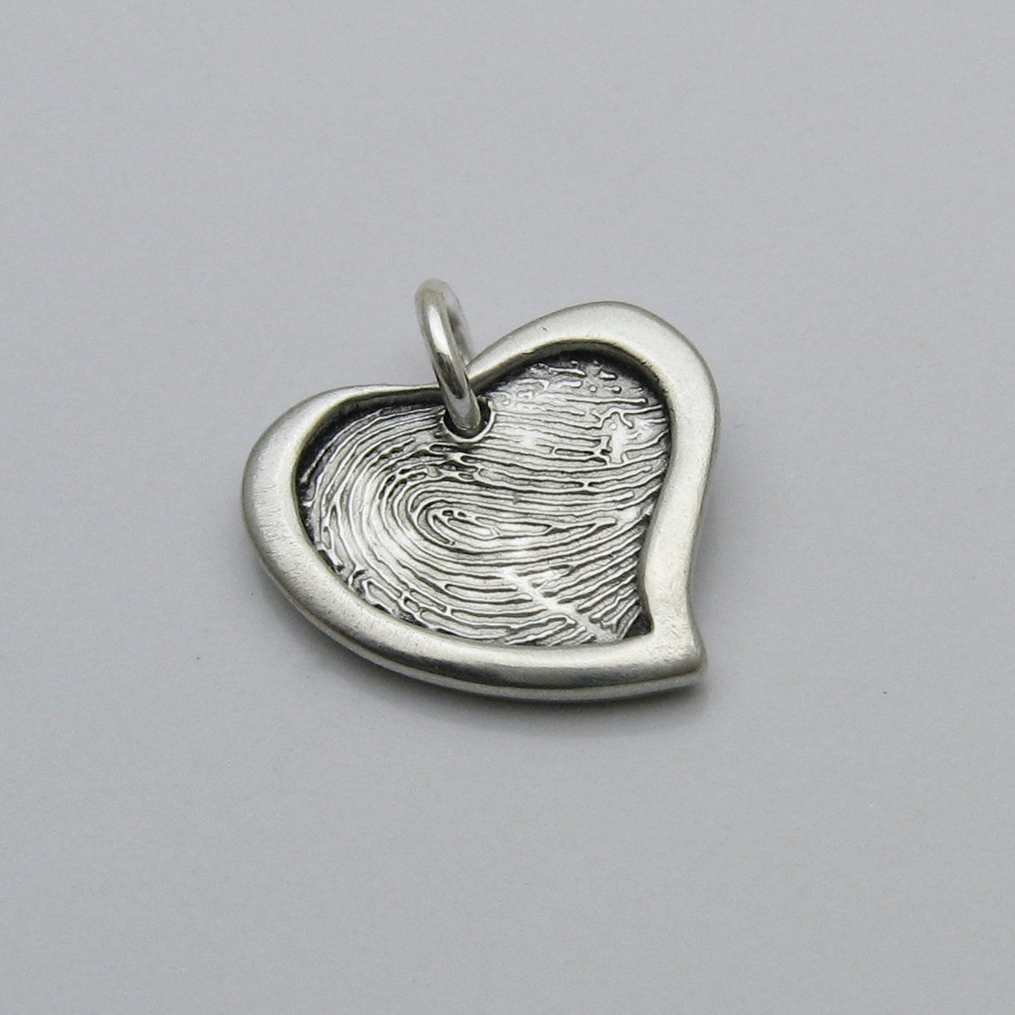 Assymetrical Heart Fingerprint Pendant With Raised Border 