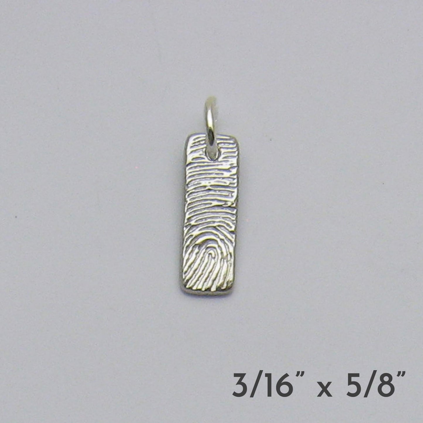 Silver fingerprint pendant on a gray background with dimensions displayed.