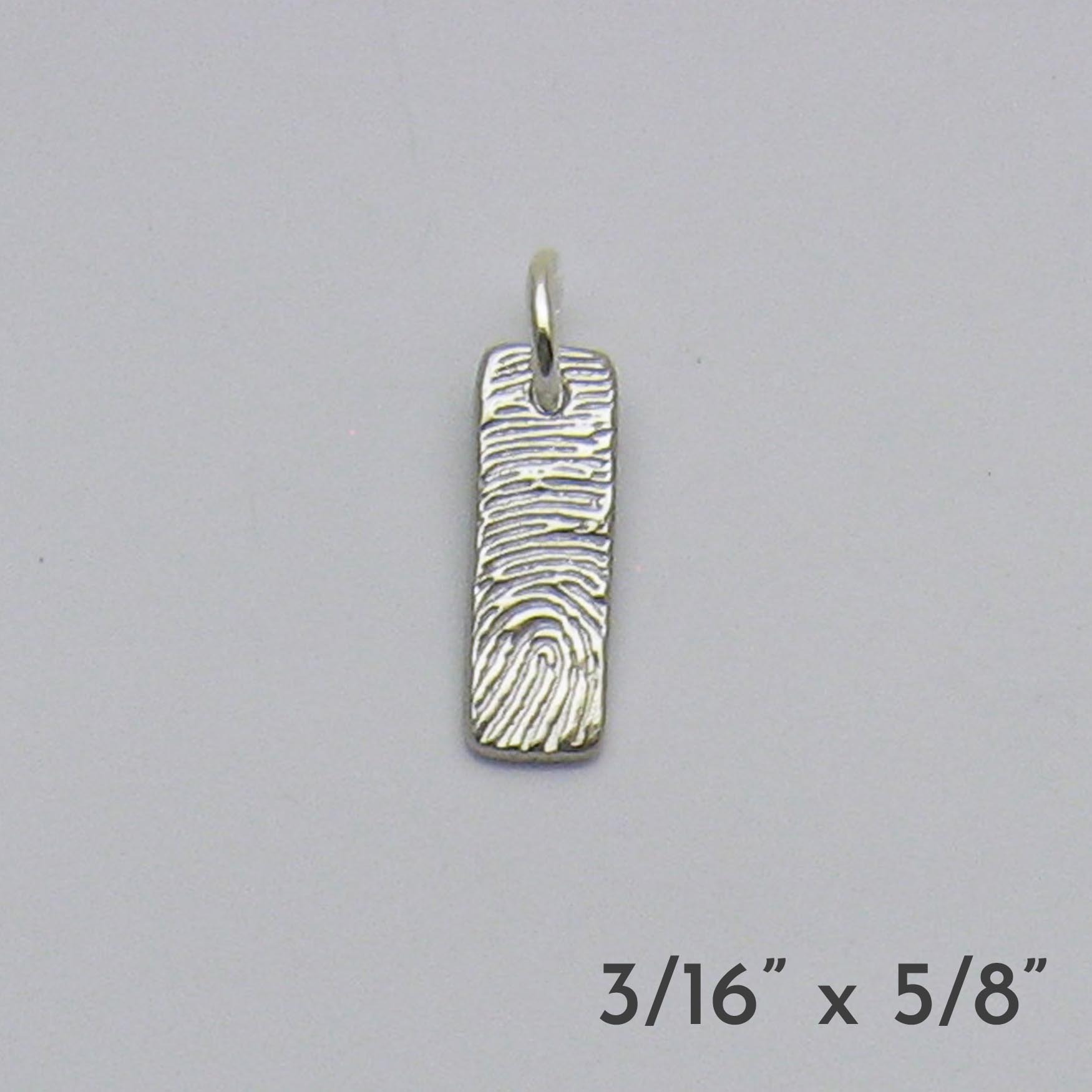 Silver fingerprint pendant on a gray background with dimensions displayed.