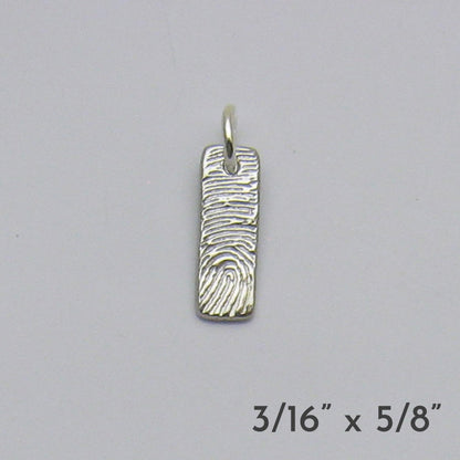 Silver fingerprint pendant on a gray background with dimensions displayed.