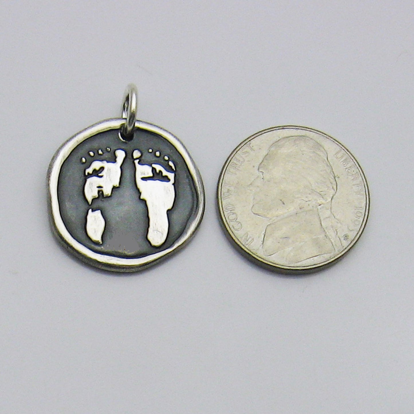 Embossed Footprint Pendant Size Reference Next to Nickel