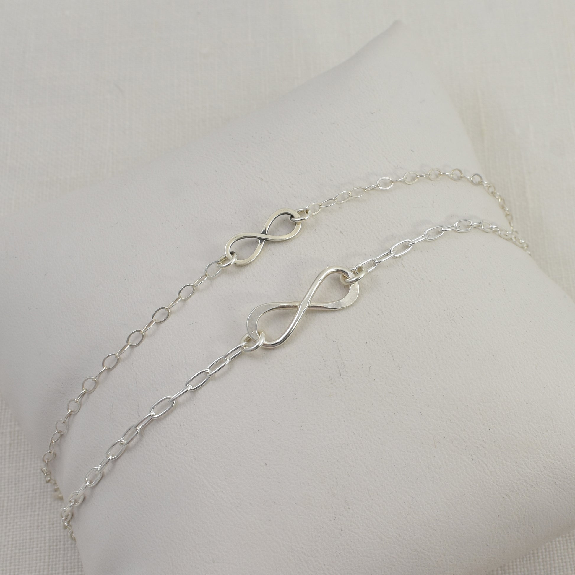 Sterling Silver Infinity Bracelets.  Small and Large infinity links are shown together in this photo.  