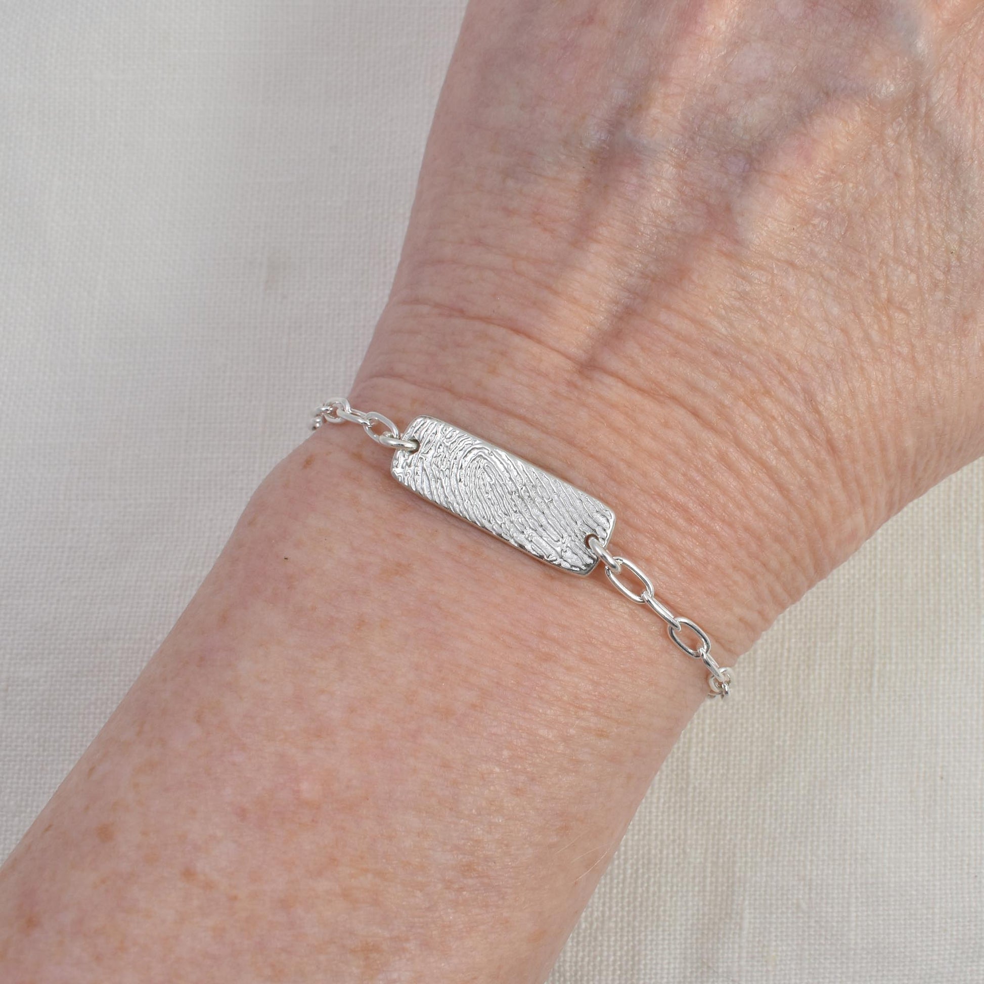 Fingerprint Bar Link Bracelet shown on wrist