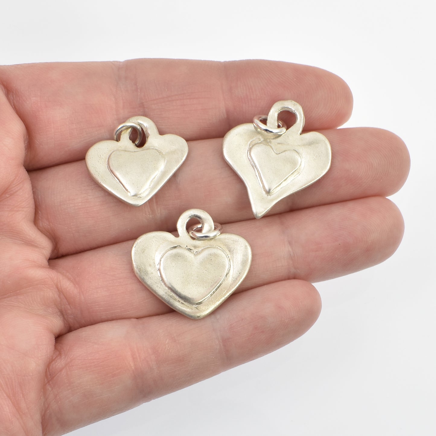 Sterling Silver Heart on Heart Charms All 3 Designs shown on hand for size reference