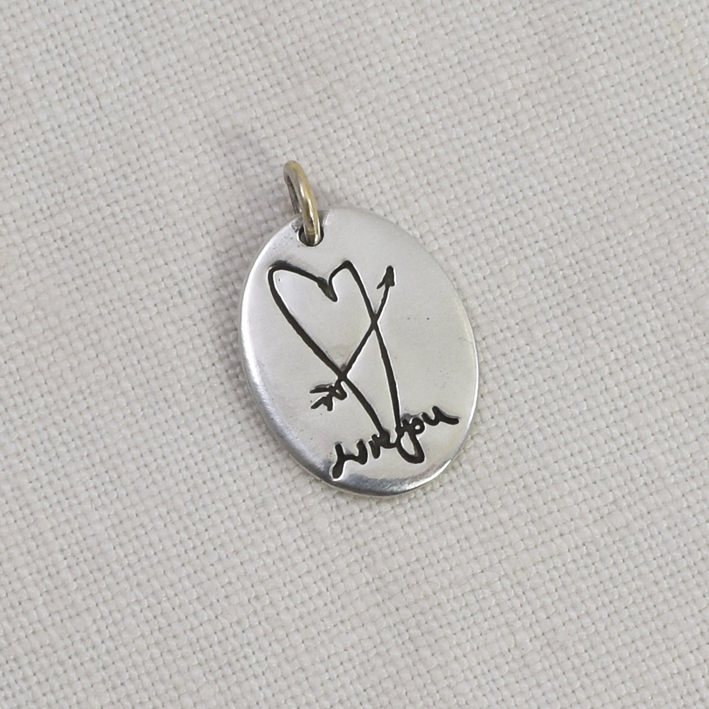 Sterling Silver Oval Pendant Engraved with a heart and arrow and handwriting