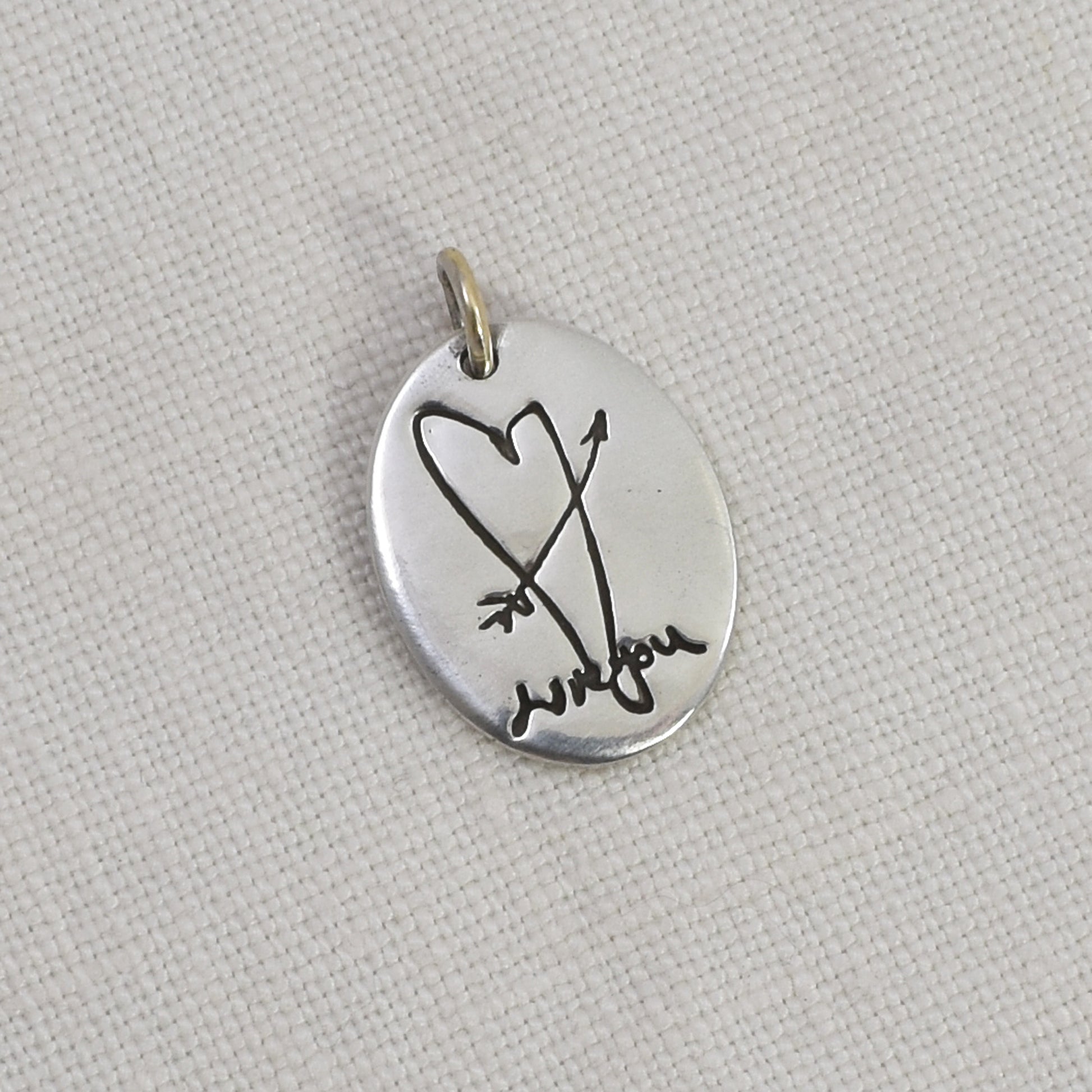 Sterling Silver Oval Pendant Engraved with a heart and arrow and handwriting