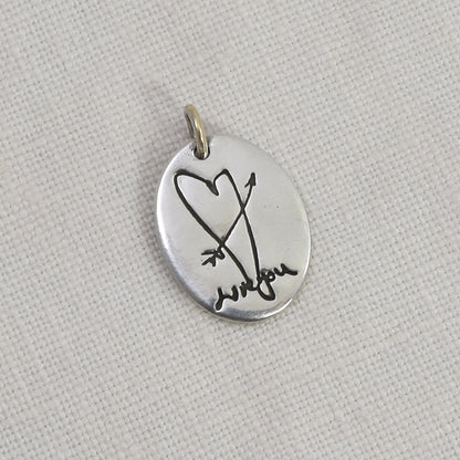 Sterling Silver Oval Pendant Engraved with a heart and arrow and handwriting
