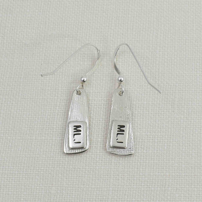 Back of Silver Fingerprint Paddle Earrings showing thin layer engraved wtih initials