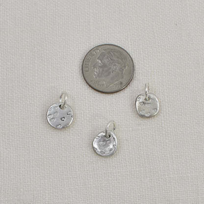 Back of 3 Tiny Sterling Silver Heart Charms shown next to a United State dime for size reference