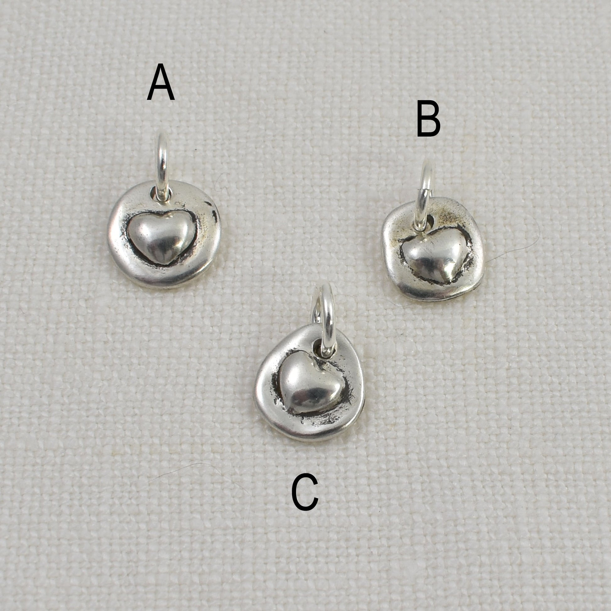 3 Tiny Sterling Silver Heart Charms with Options A, B and C indicated above each charm