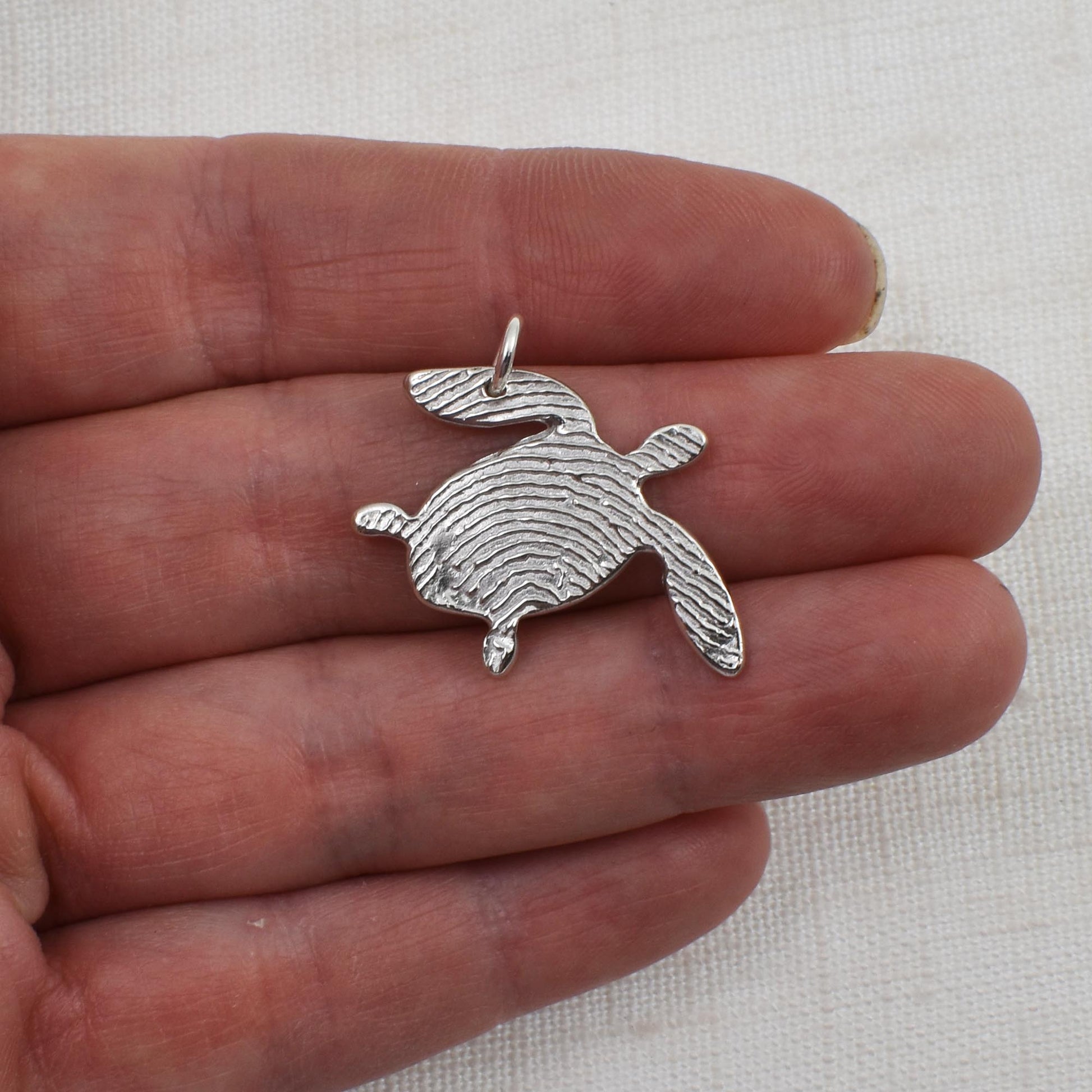 Sterling Silver Sea Turtle Fingerprint Pendant Shwon on hand for size reference