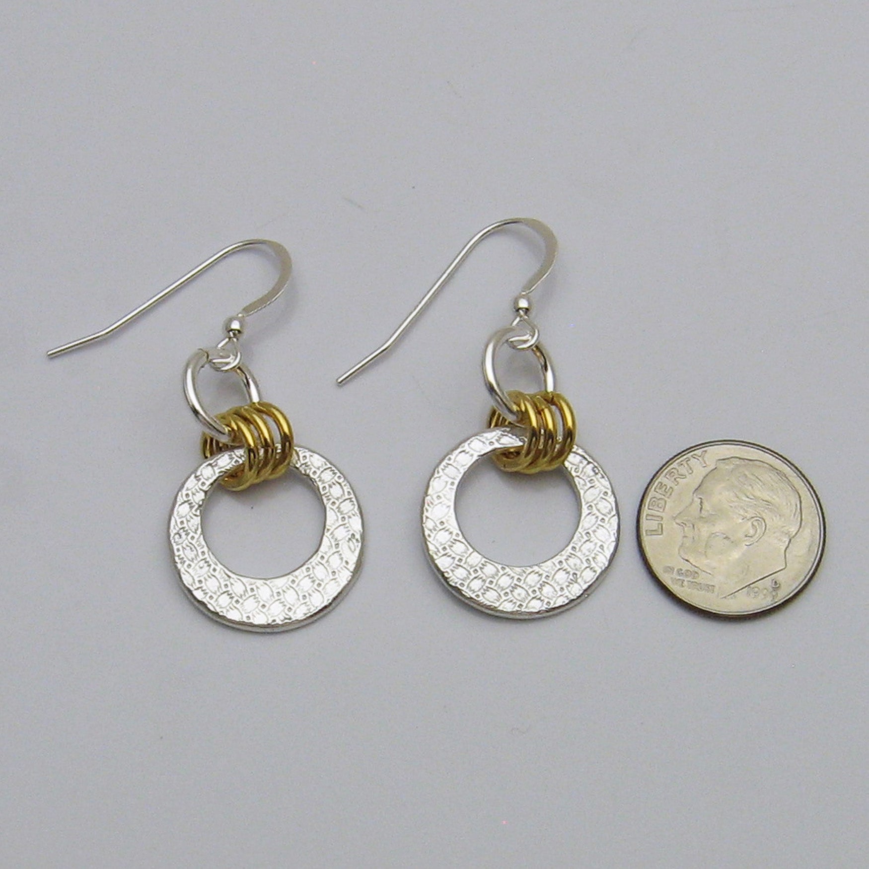 Silver and Gold Open Circle Earrings Shown next to a United State dime for size reference