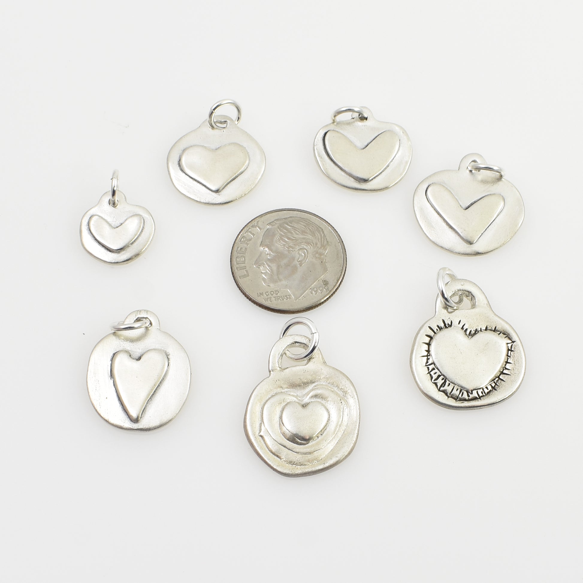 Timeless Hearts - Hearts on Circles All Charms next to dime for size reference